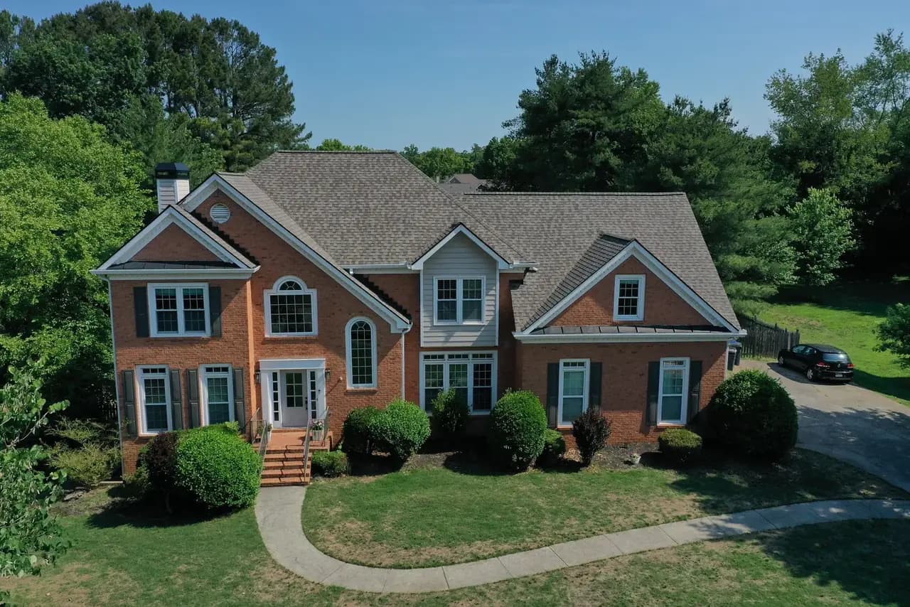A North Georgia roof before and after a legitimate storm-damage replacement by Platinum Roofing