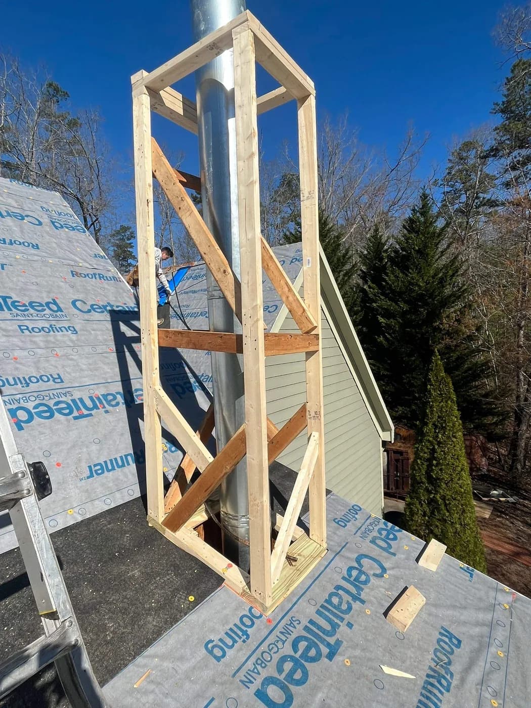 New chimney framing rebuilt and wrapped before siding and shroud installation in North Atlanta