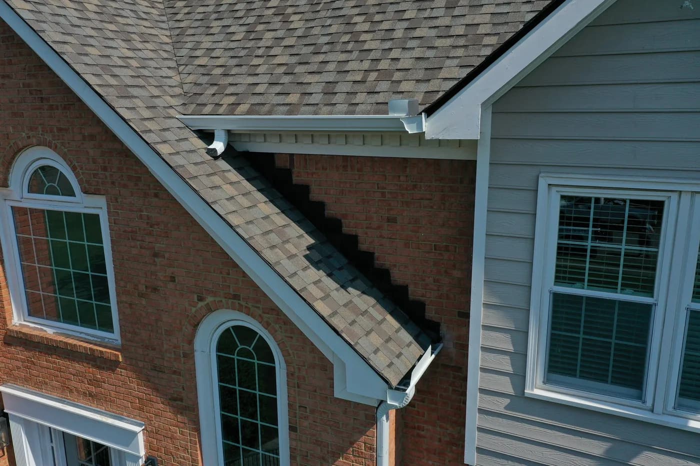 Detail of an oversized downspout and seamless gutter outlet installed in North Georgia