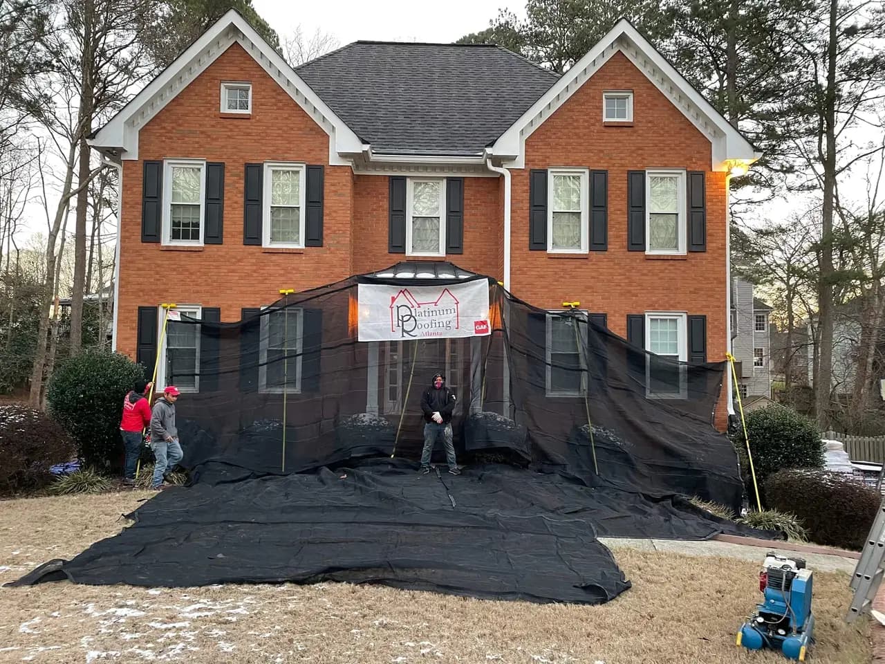 Active roof replacement job site protected with tarps by Platinum Roofing