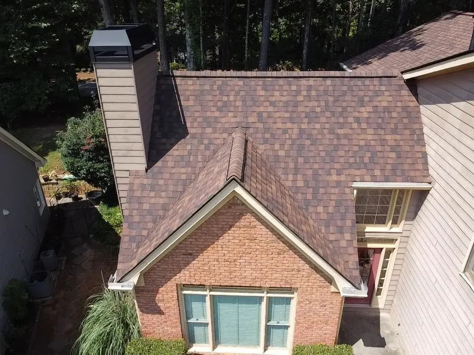 Brick home with a completed shingle roof in Alpharetta, GA