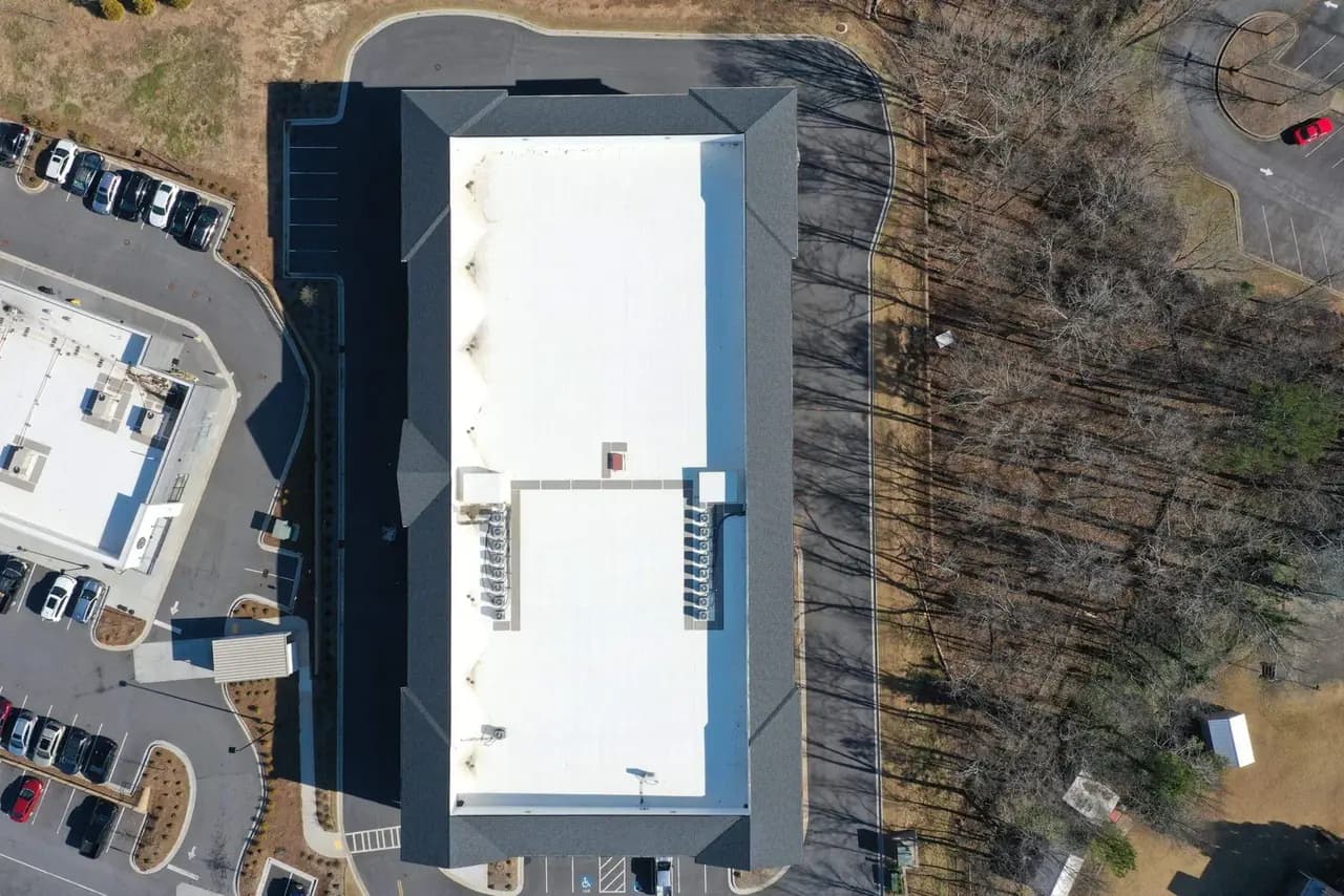 Platinum Roofing technician installing a white TPO membrane on a low-slope commercial roof in metro Atlanta