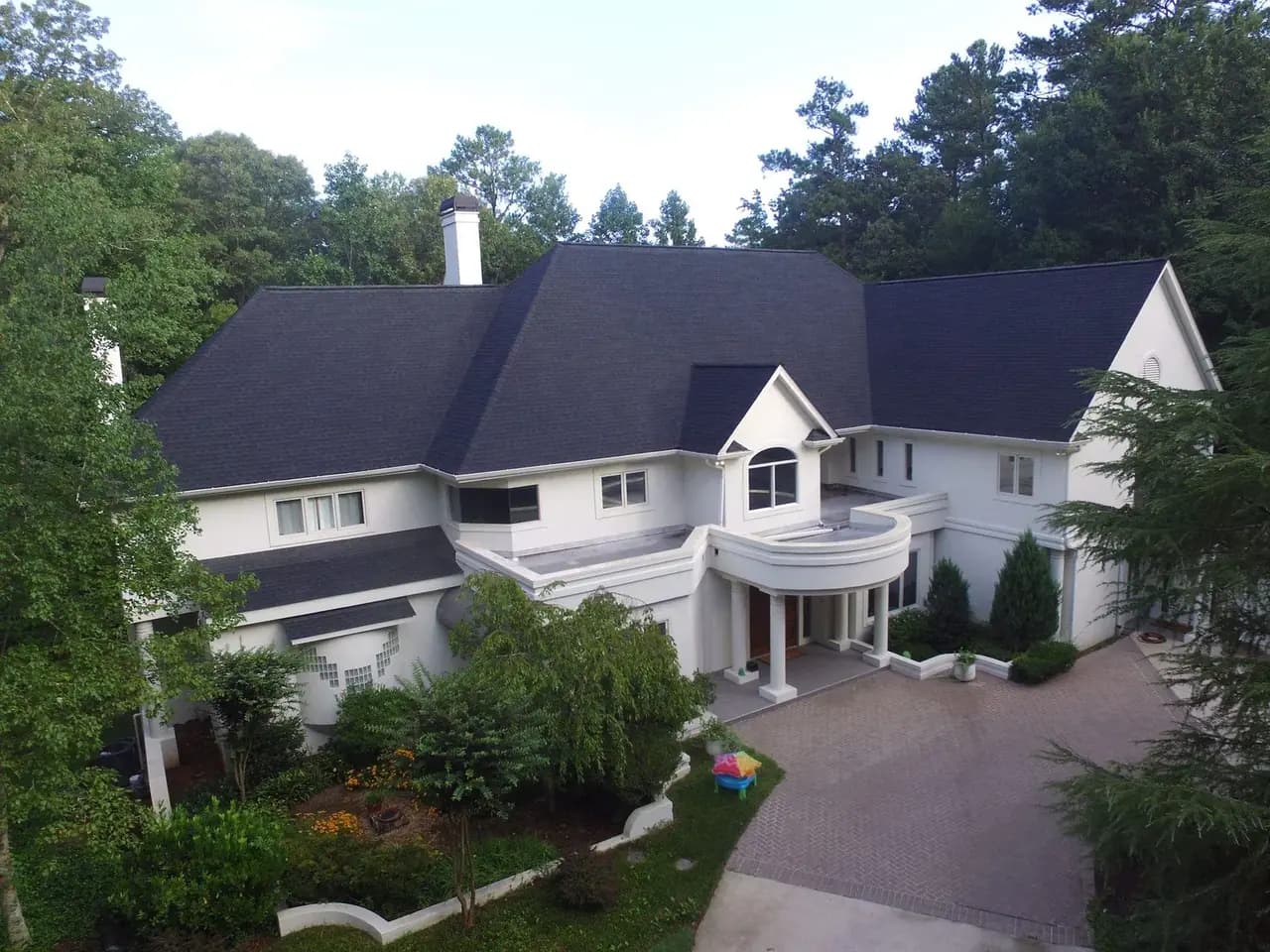 Newly installed seamless aluminum gutters along the roofline of a North Atlanta home
