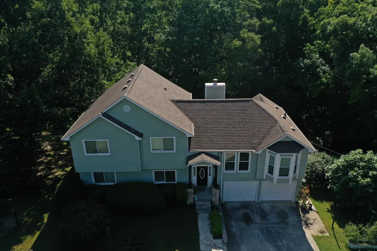 Aerial view of a finished shingle roof on a two-story home in Canton, GA