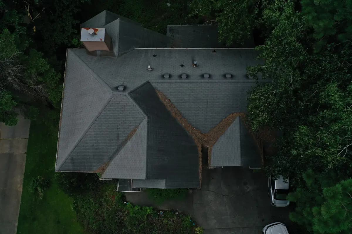 Aerial view of a complex roofline on a Johns Creek, GA home