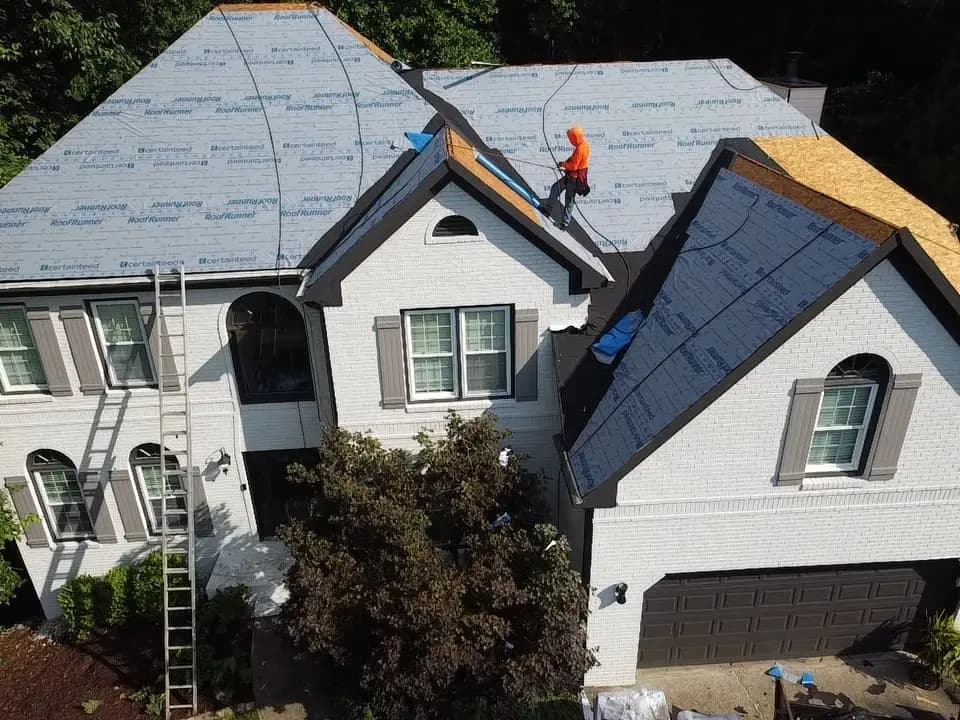 Crew installing underlayment on a Woodstock, GA roof