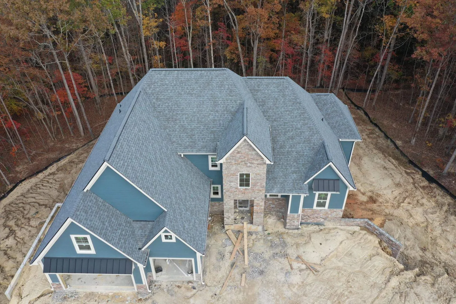 A large new build in North Georgia with a fresh architectural shingle roof installed by Platinum Roofing, viewed from above