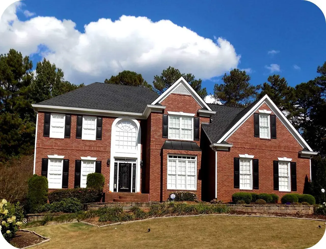 A finished brick home in North Georgia with a new architectural shingle roof installed by Platinum Roofing
