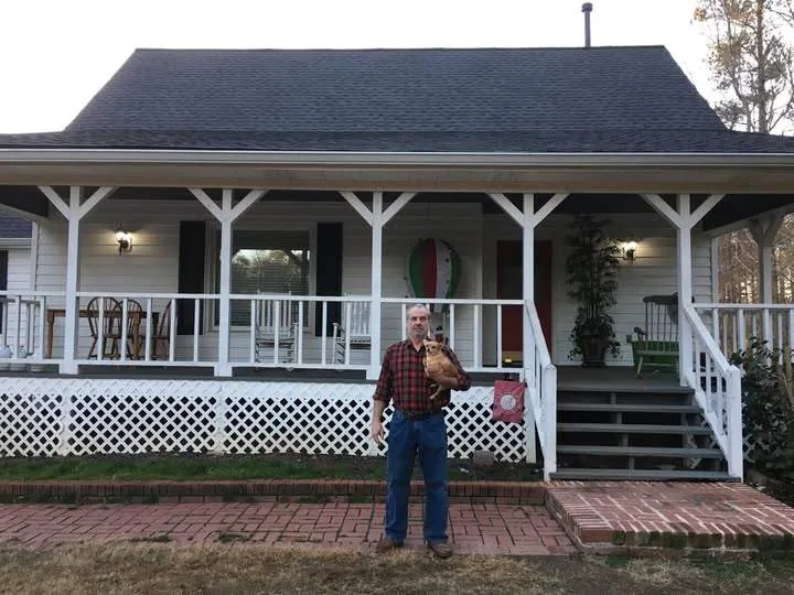 A North Georgia homeowner standing in front of their home after a new roof from Platinum Roofing